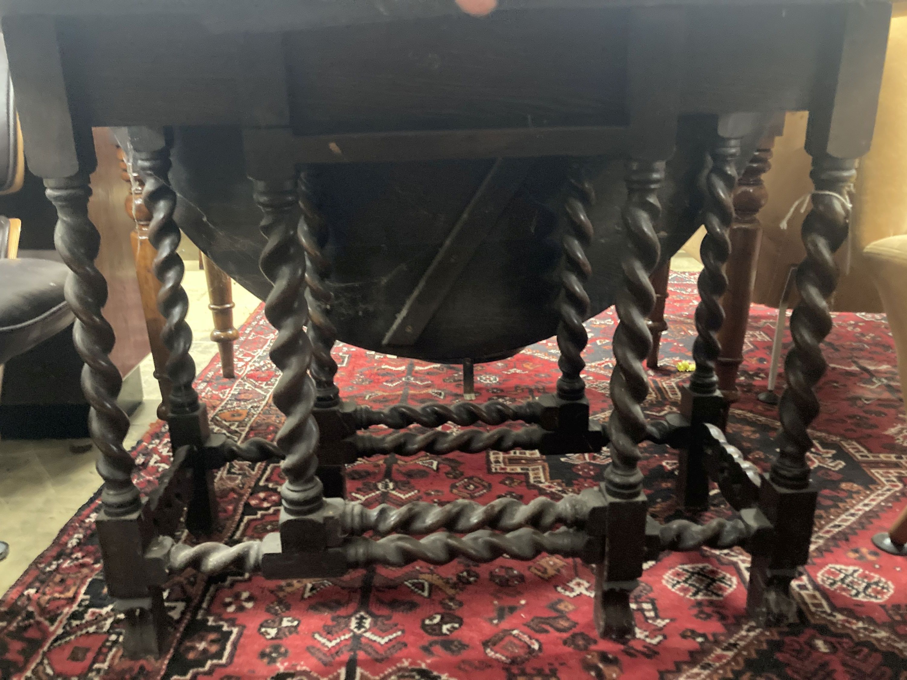 A 1920's oak topped gateleg dining table, on spiral twist legs, width 106cm, depth 40cm, height 76cm